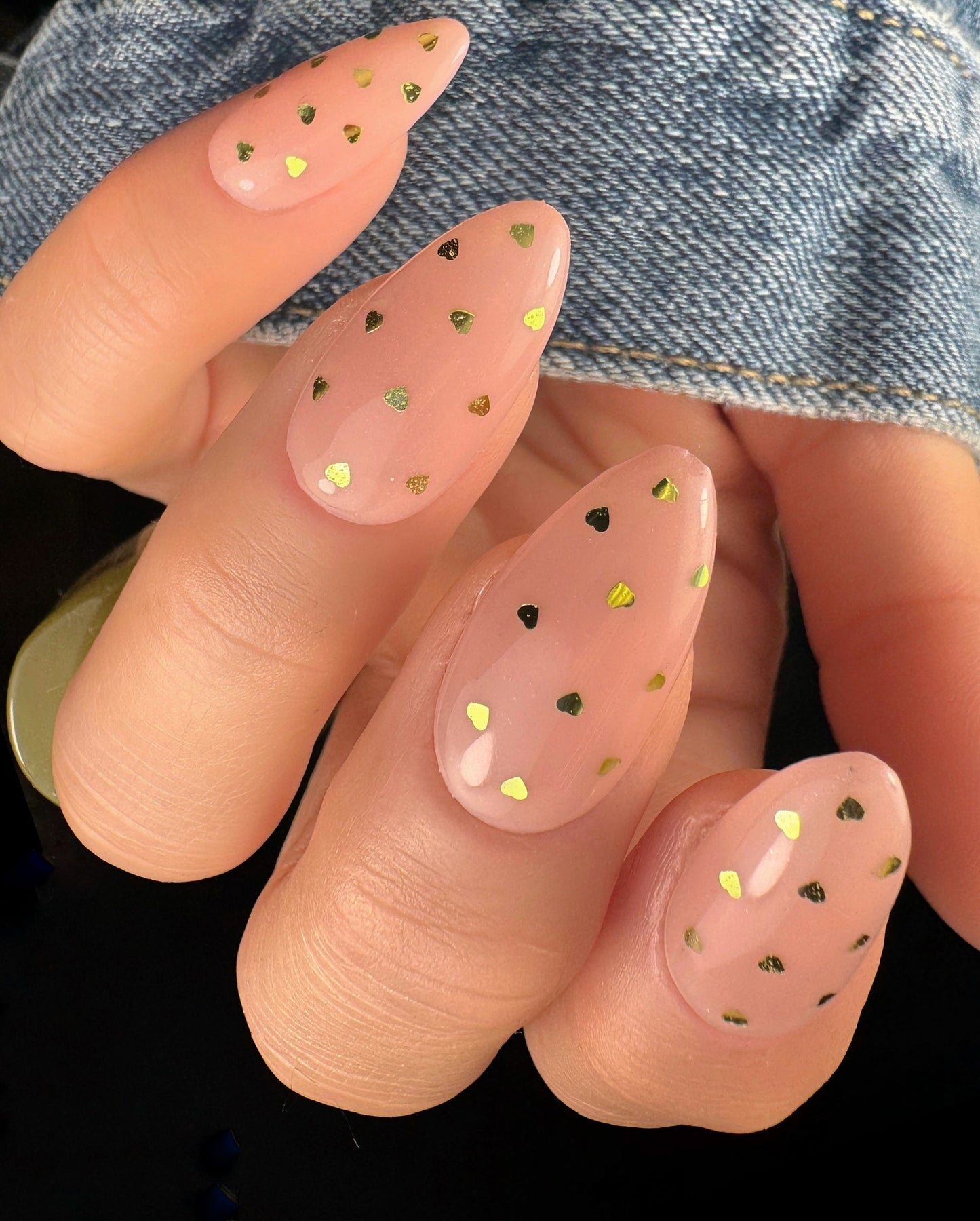 Nail art with small decorative hearts on a clear background