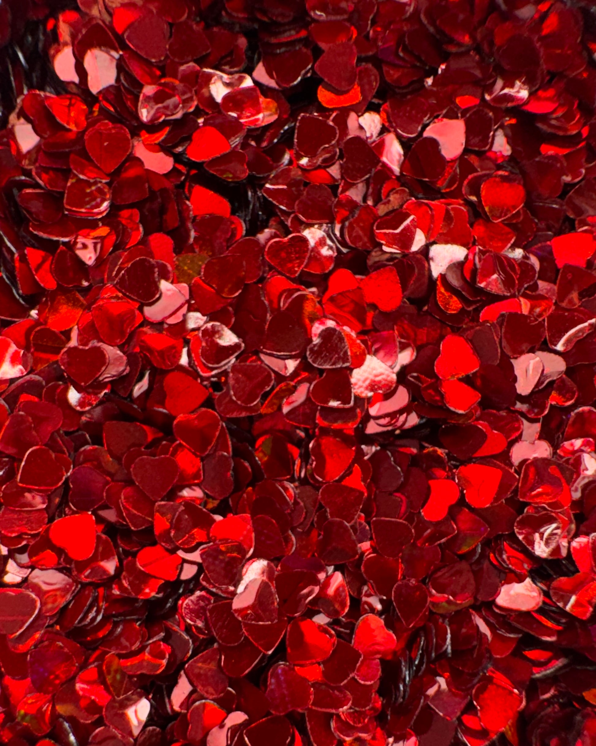 Red heart-shaped glitter with a shiny texture
