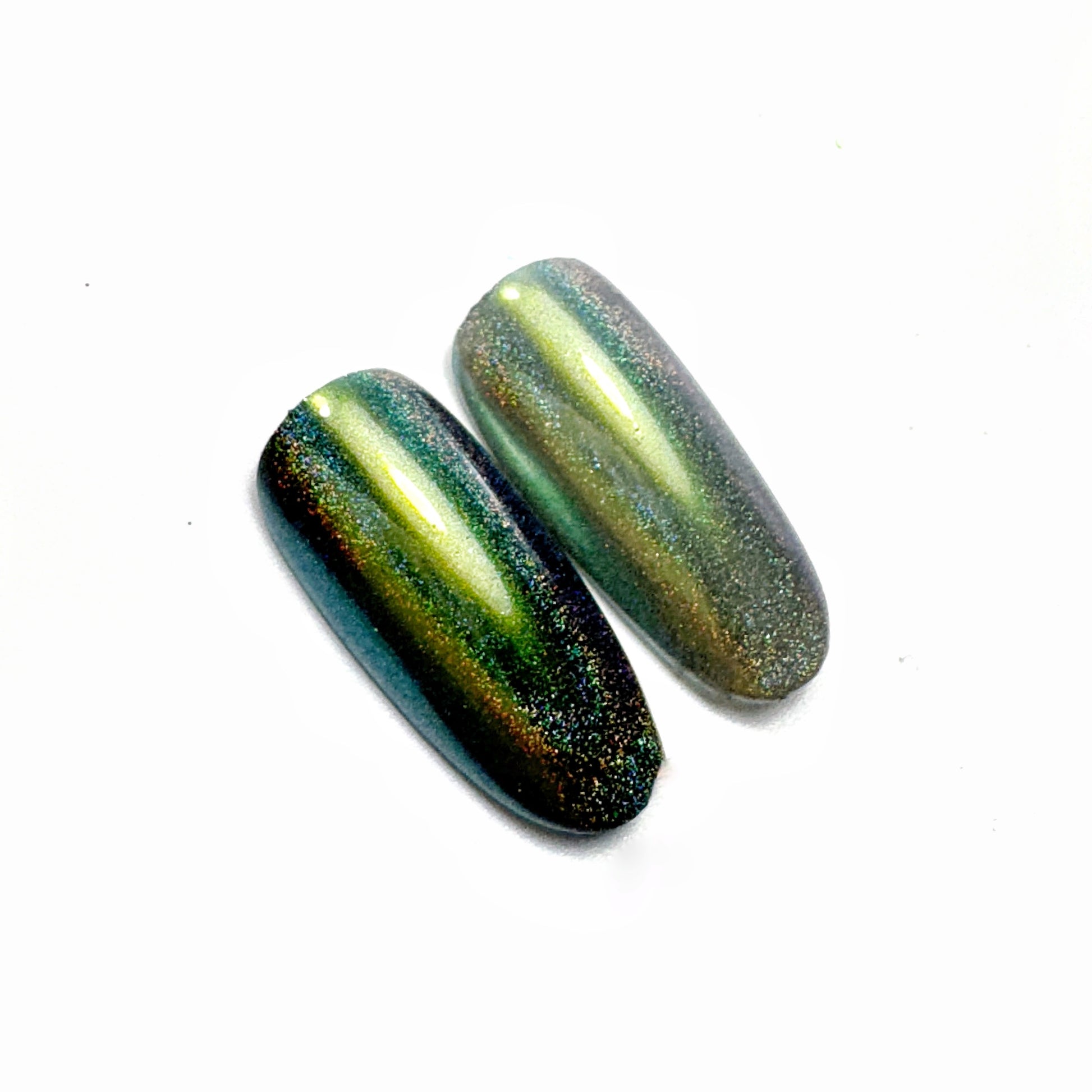 Nail tips with iridescent finish on white surface,