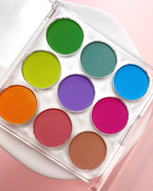 Colorful nail pigment palette on a pink background