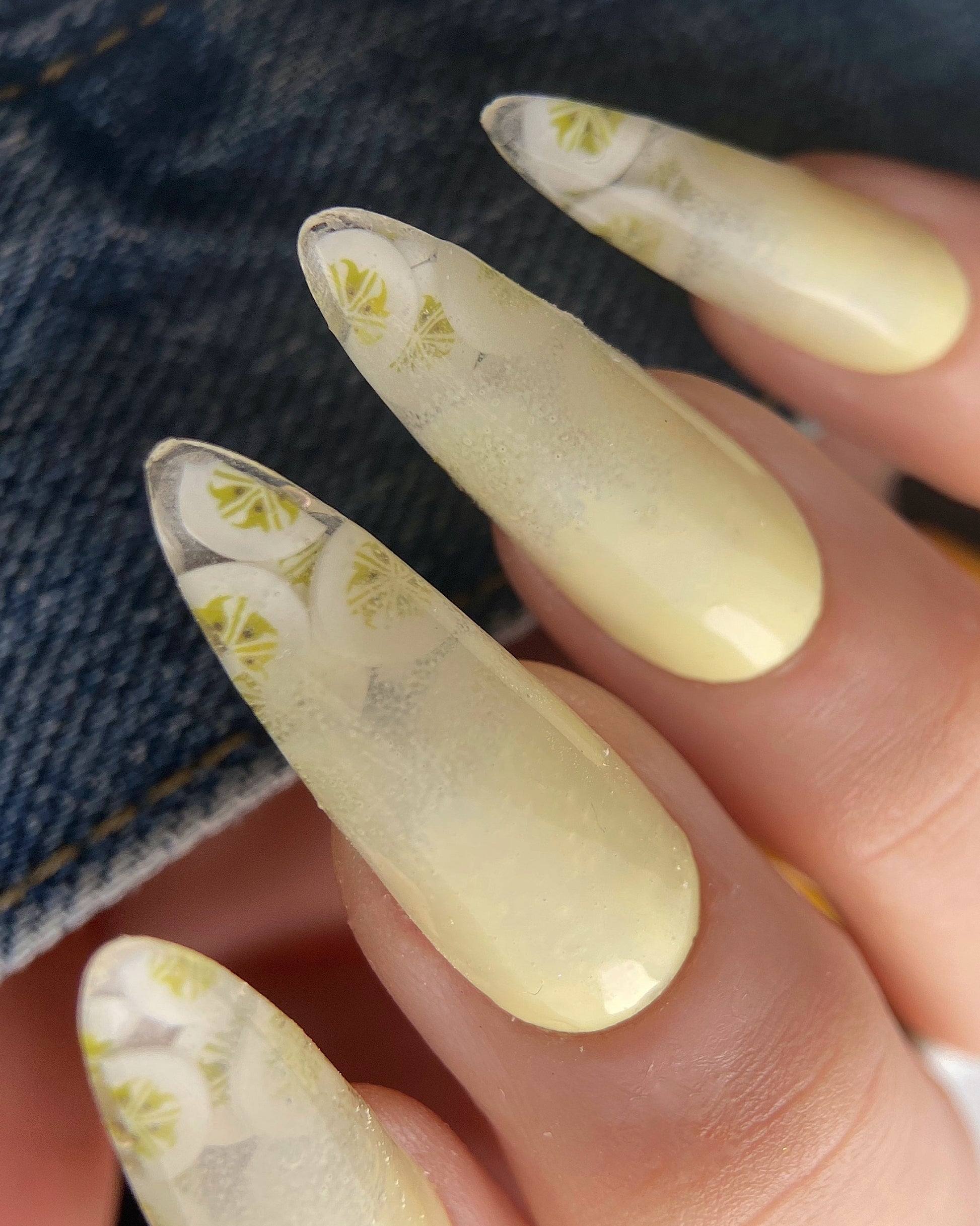 Nails with a banana design on a denim background