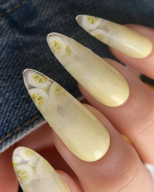 Nails with a banana design on a denim background