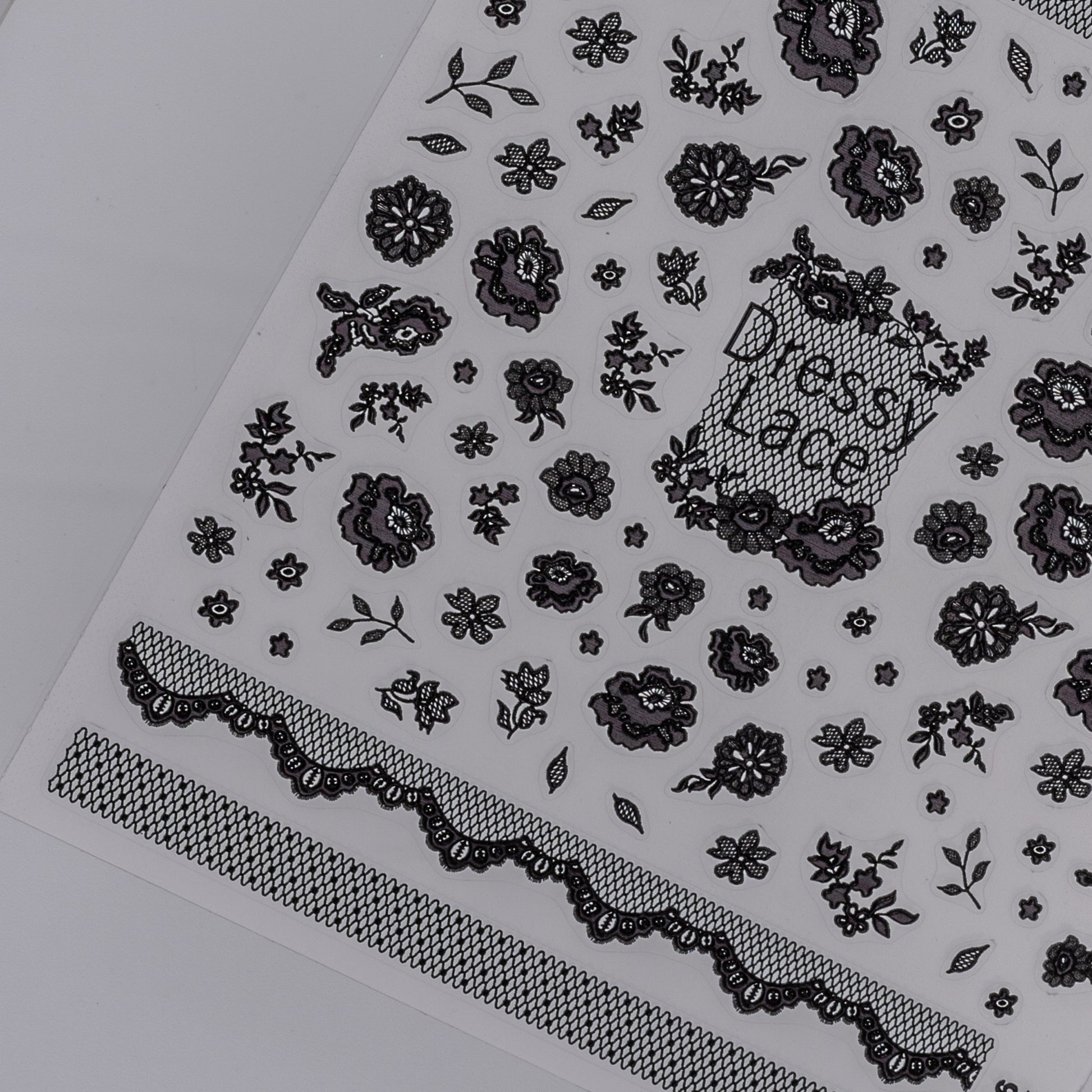 Black floral and lace pattern nail sticker sheet  on a white background