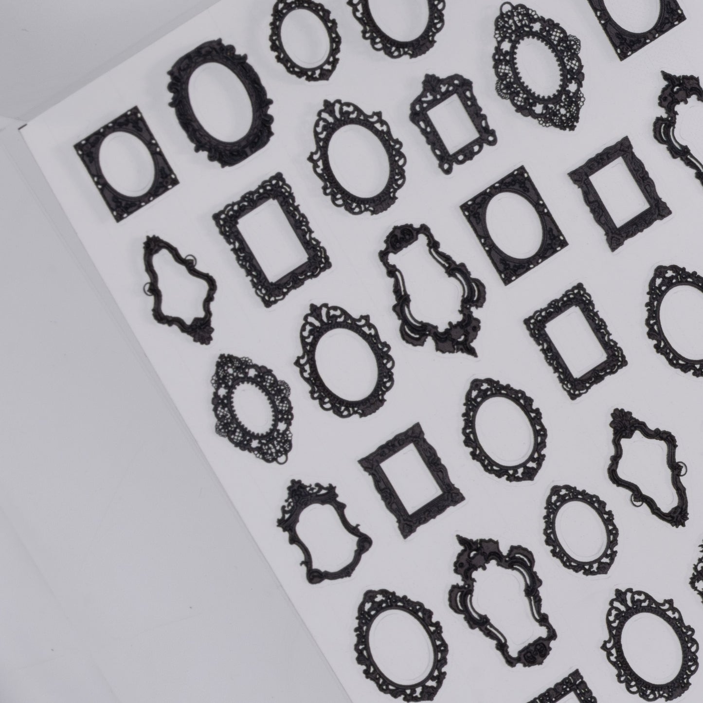 Sheet of black decorative frame nail stickers a white background
