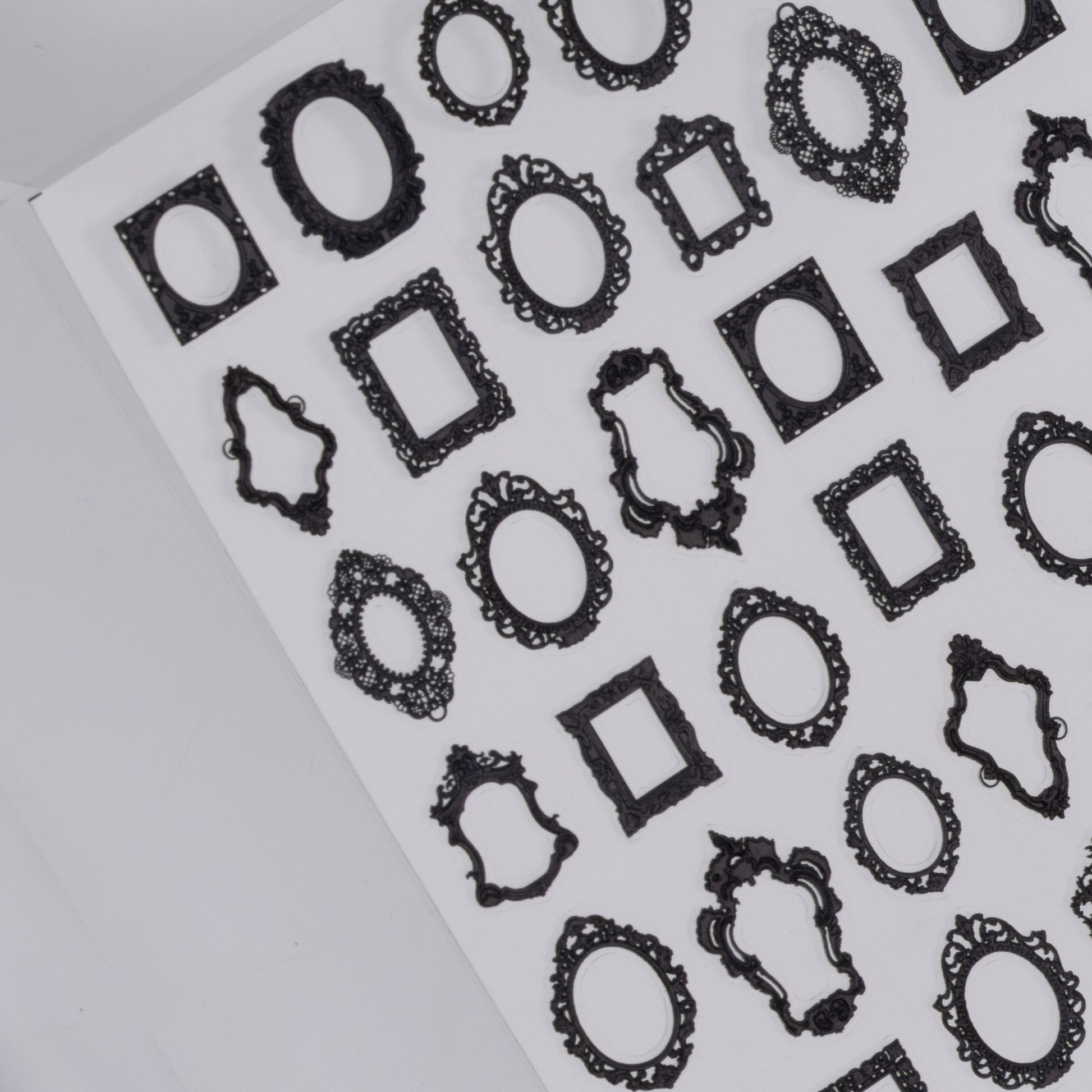 Sheet of black decorative frame nail stickers a white background