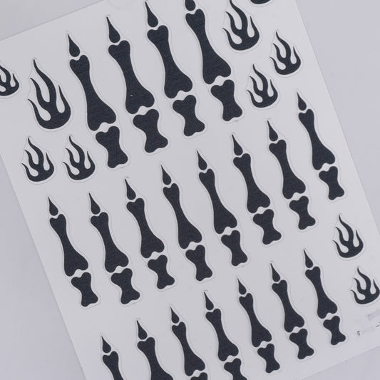 Sheet of black bone and flame designs on a white background