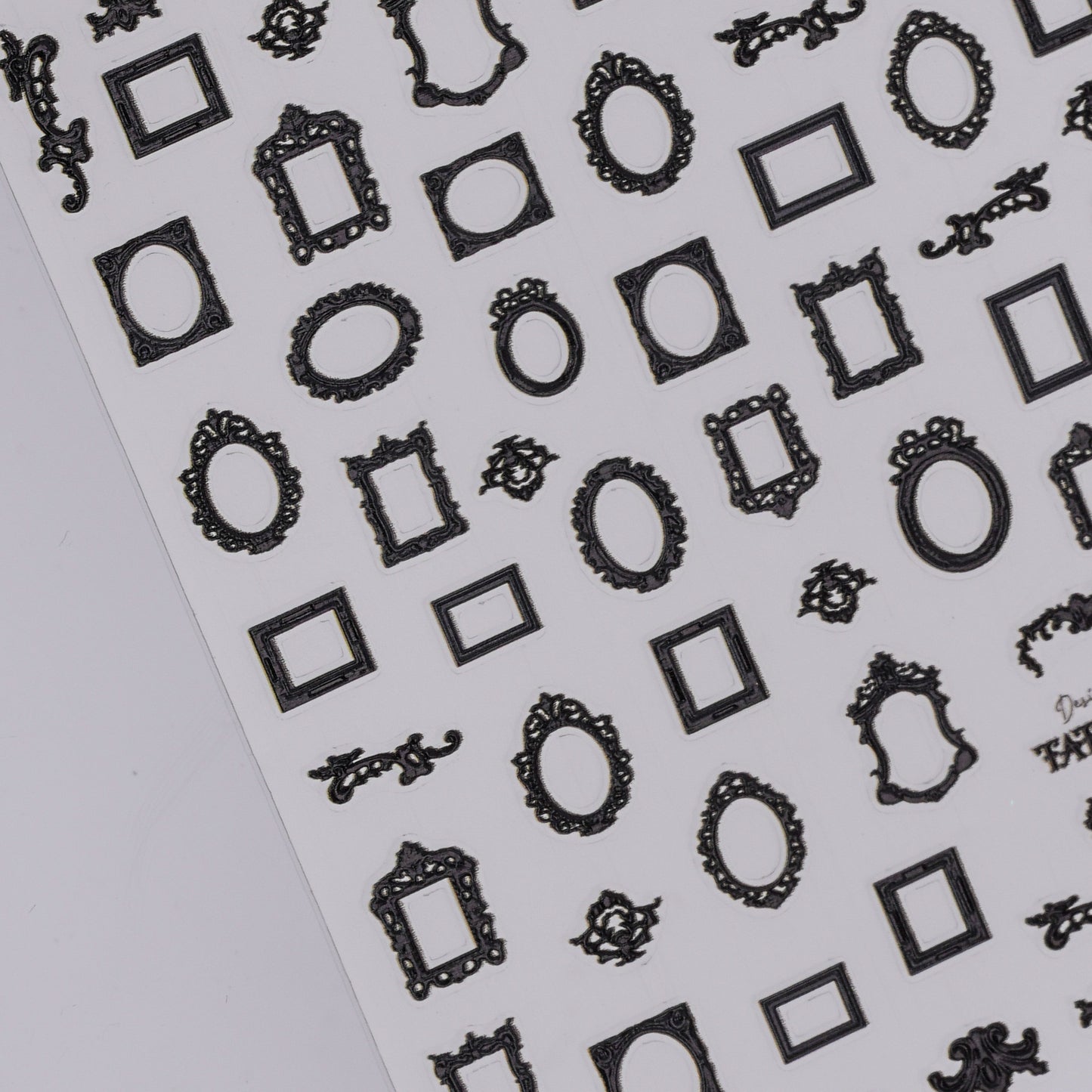 Sheet of black decorative frame nail stickers on a white background