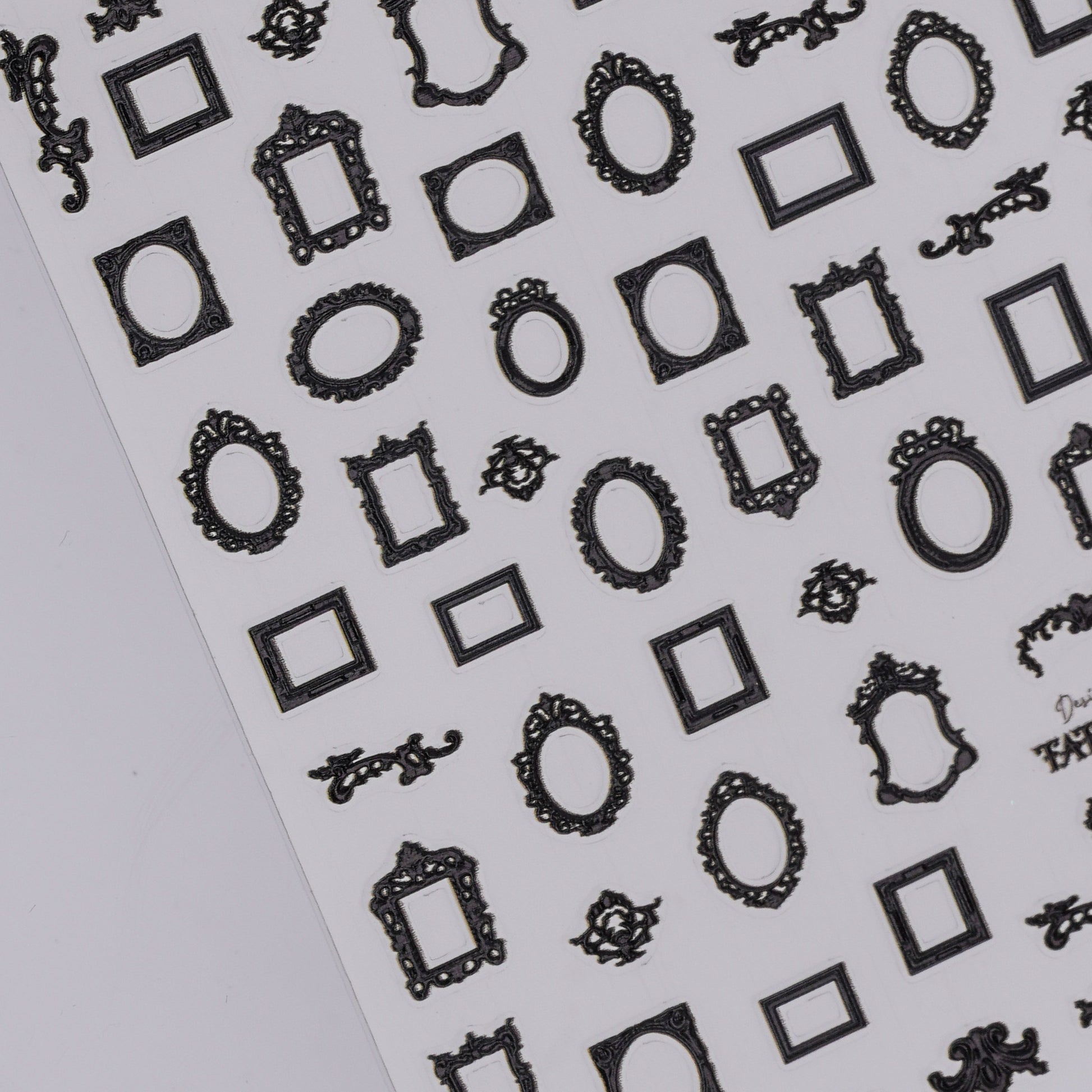 Sheet of black decorative frame nail stickers on a white background