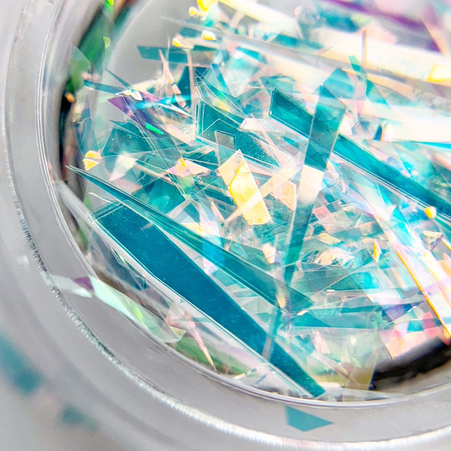 Close-up of colorful sliced mylar in a clear container