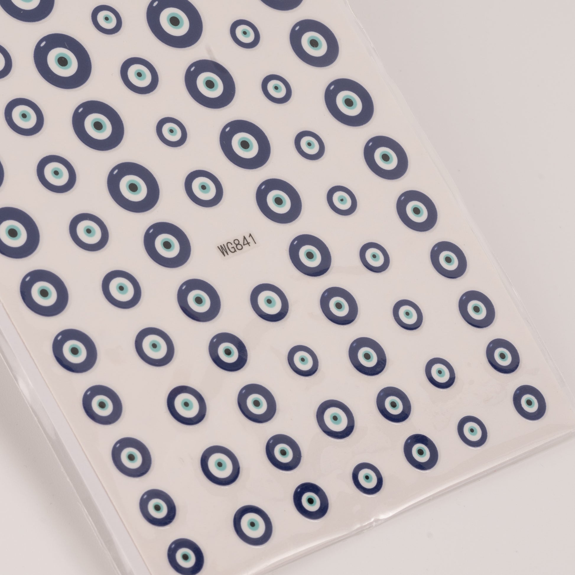 Nail decal sheet with blue eye design on light background.