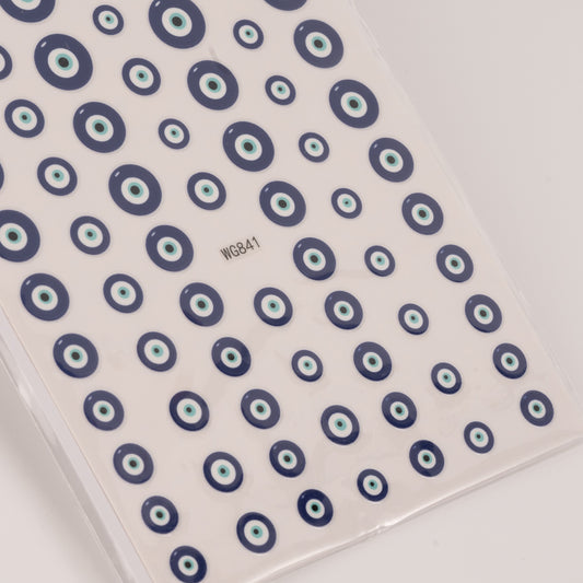 Nail decal sheet with blue eye design on light background.