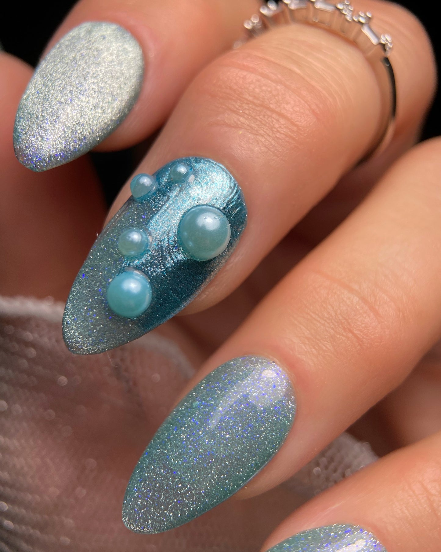 Nails with blue and silver glitter design