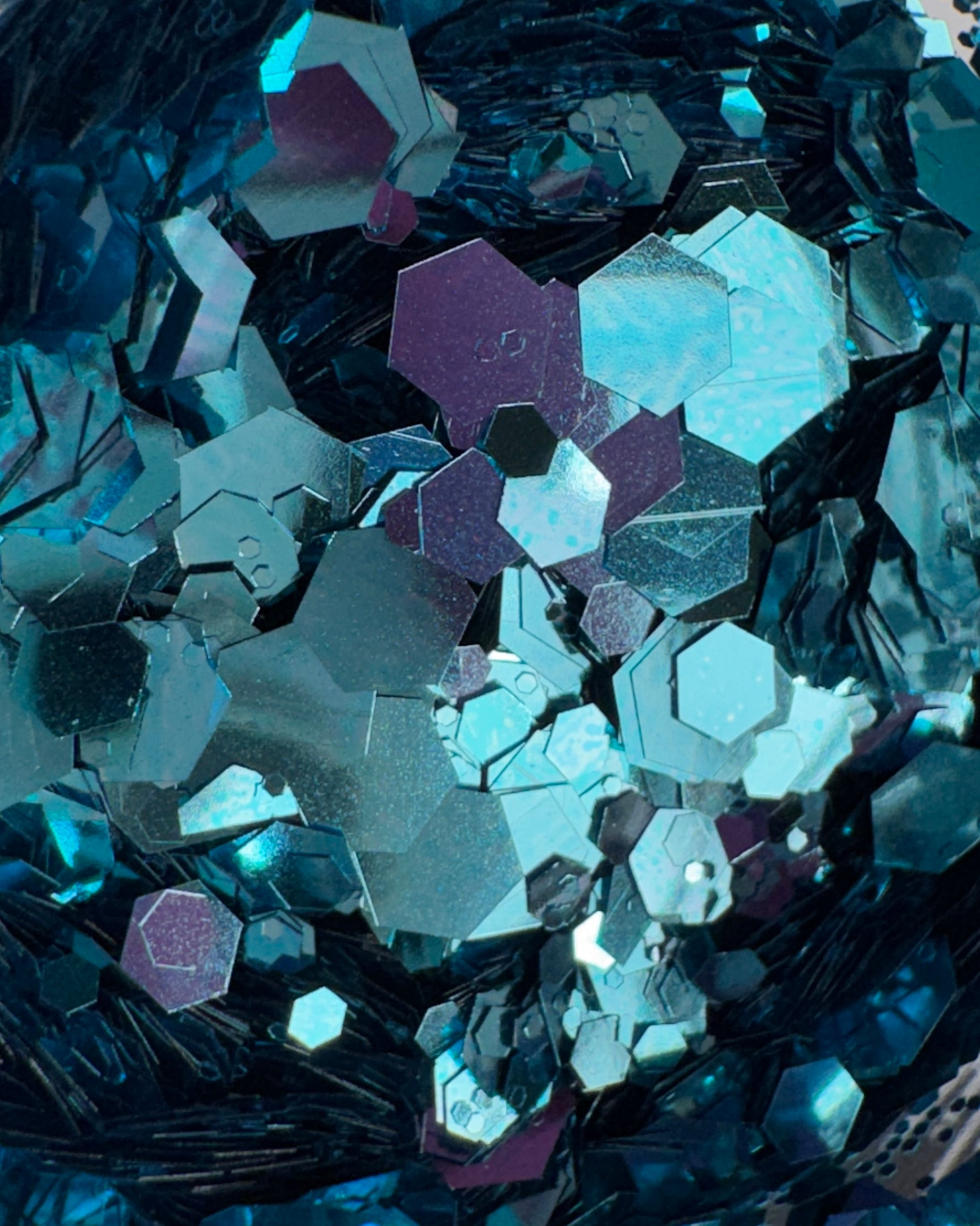 Close-up of metallic hexagonal blue glitter mix.