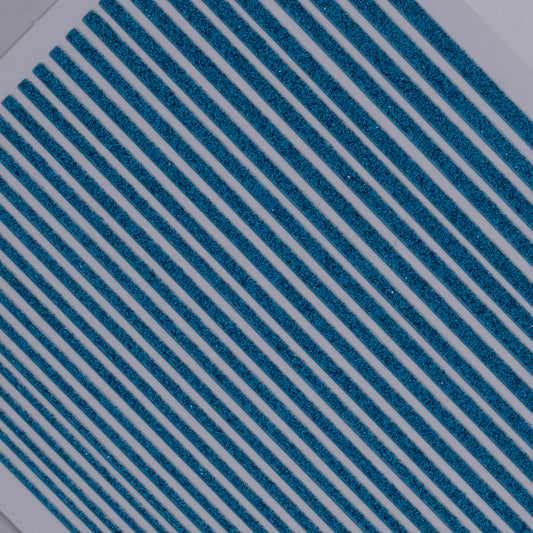 Close-up of nail decal sheet featuring blue glitter stripes.