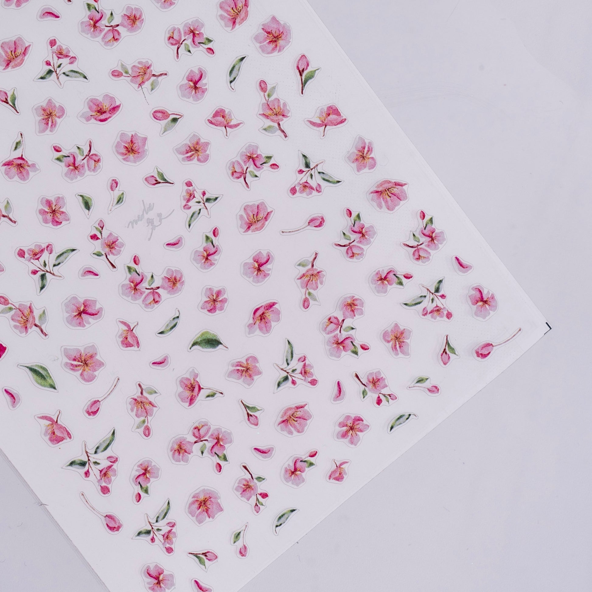 Sheet of pink floral stickers on a white background
