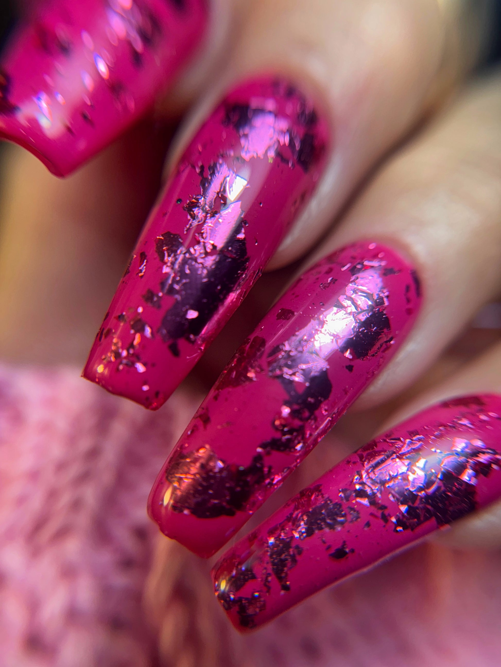 Close-up of pink nails with glittery accents