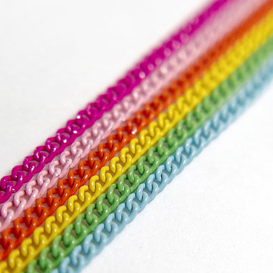 Close-Up of Multi-Color Nail Art Chains in vivid tones on White Background.