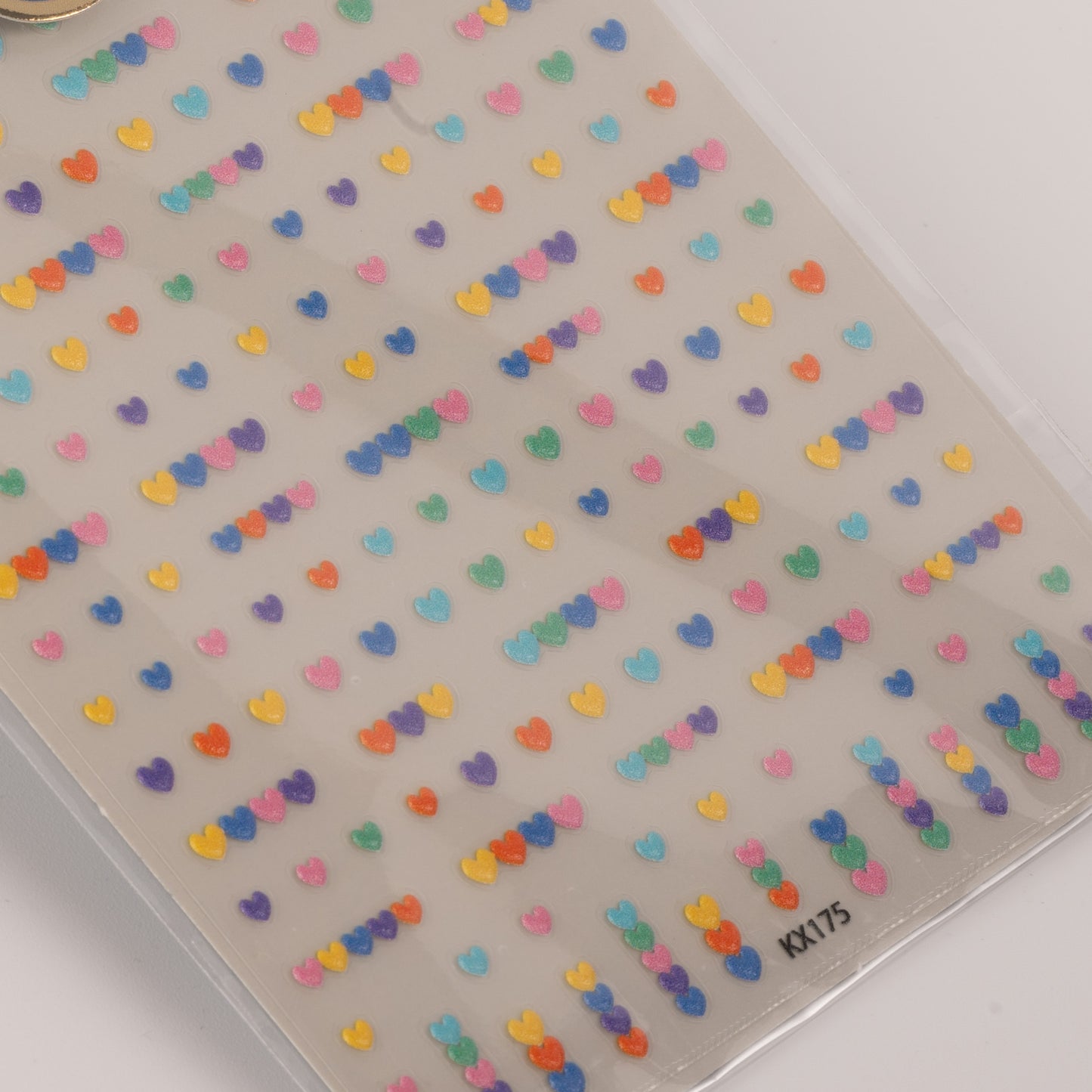 Sheet of colorful heart-shaped stickers on a clear background