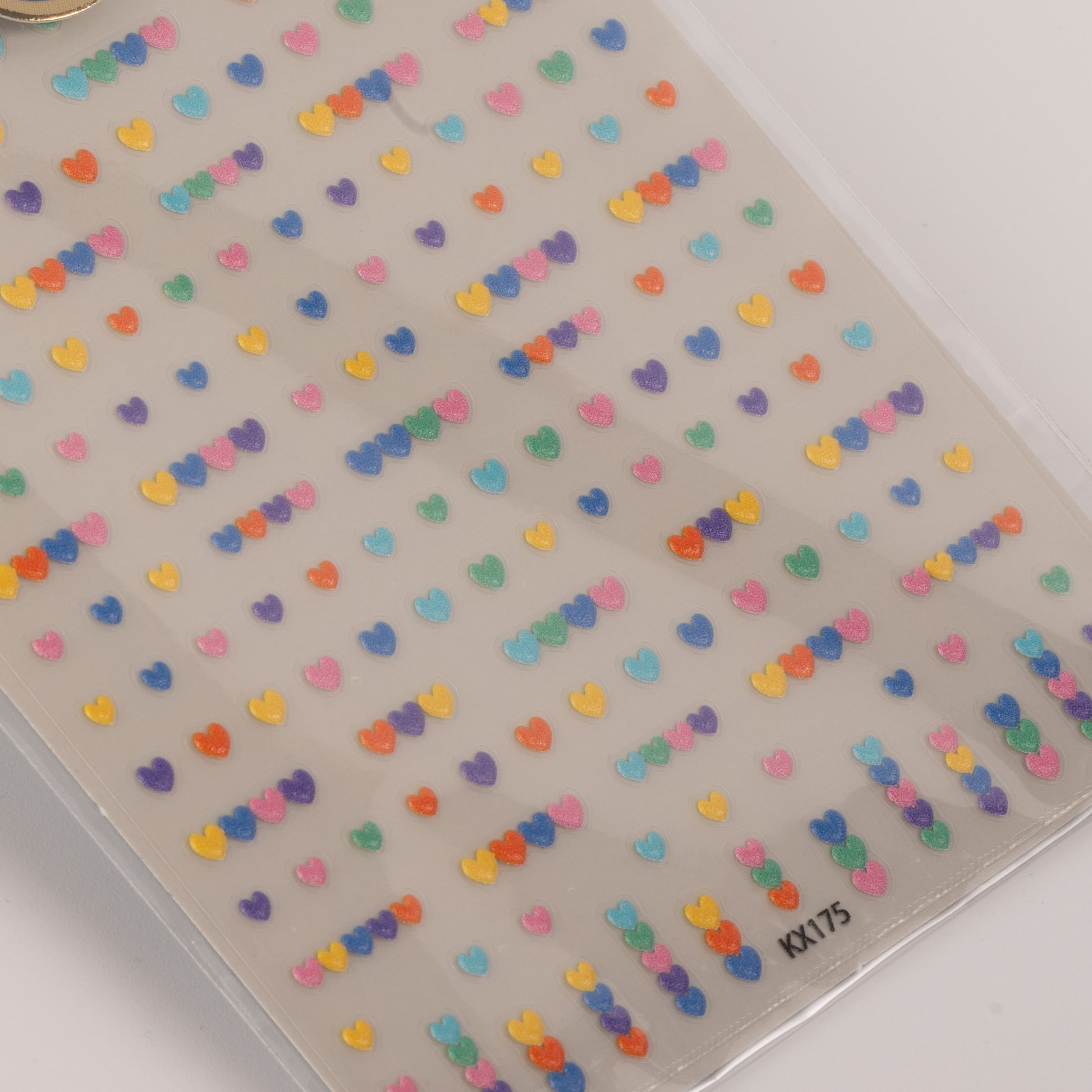 Sheet of colorful heart-shaped stickers on a clear background
