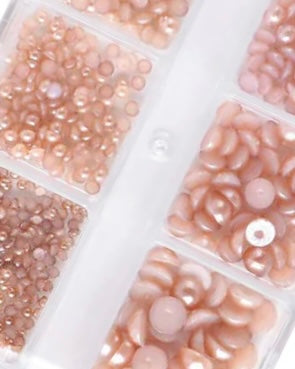 Close-up of beige beads in a clear plastic organizer.