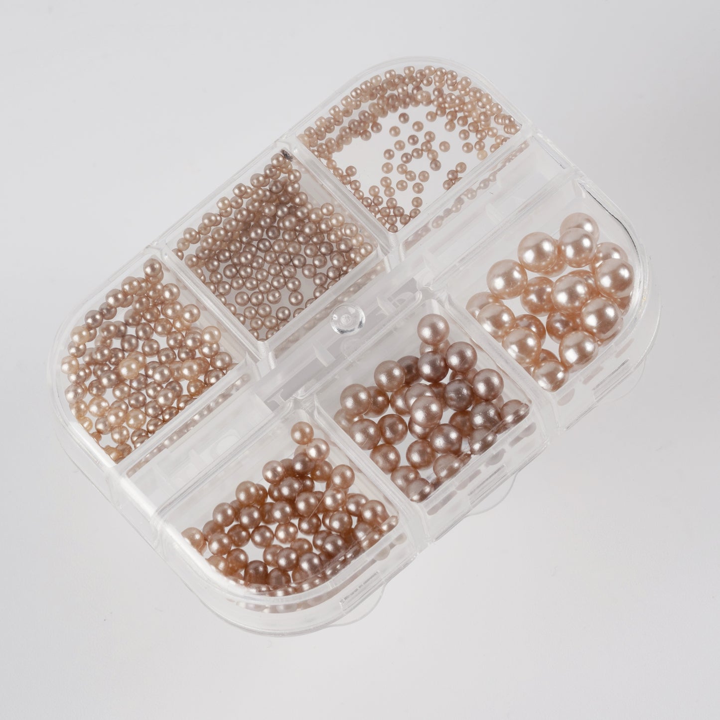 Clear case with brown pearls on white background.