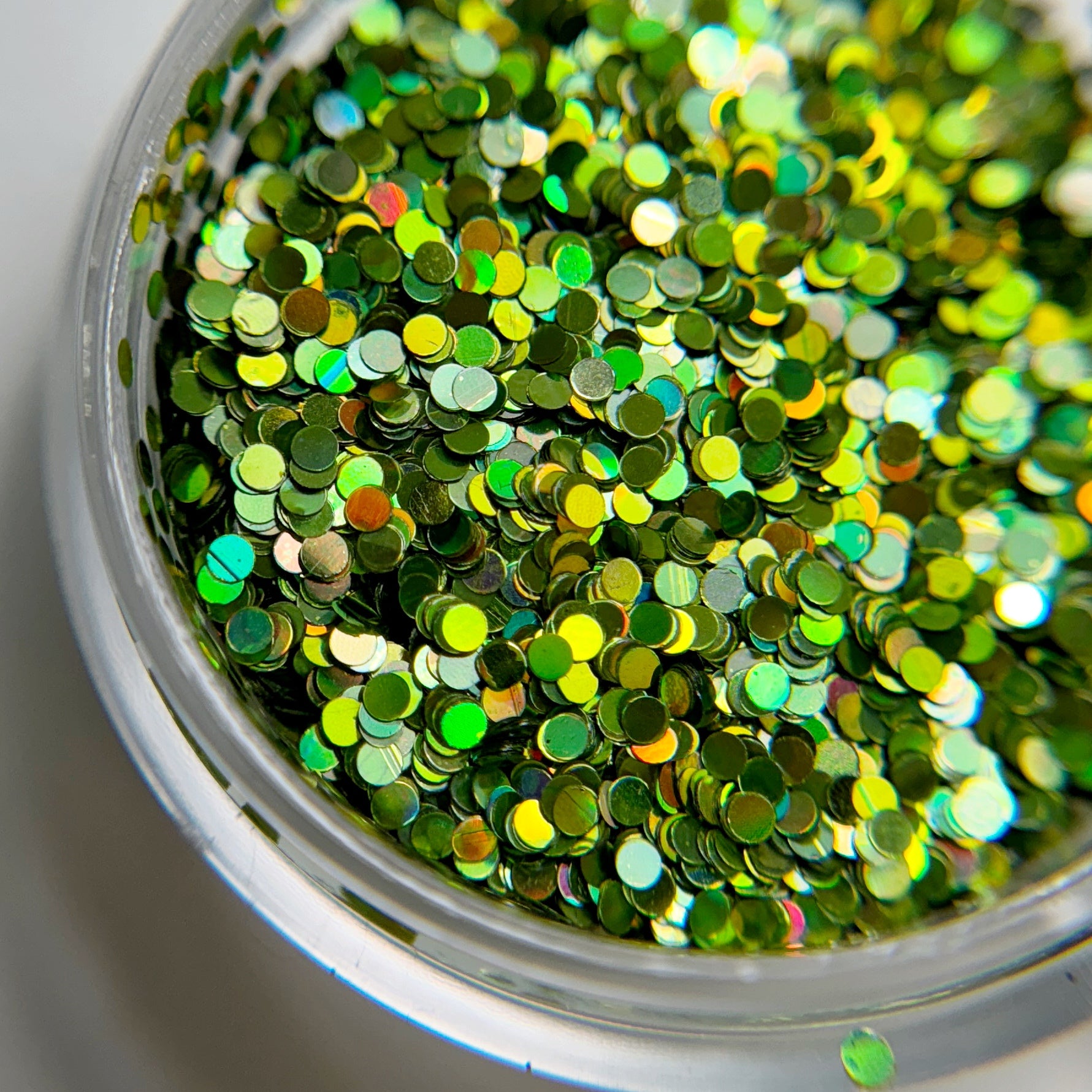 Close up of chunky glitter in clear container.