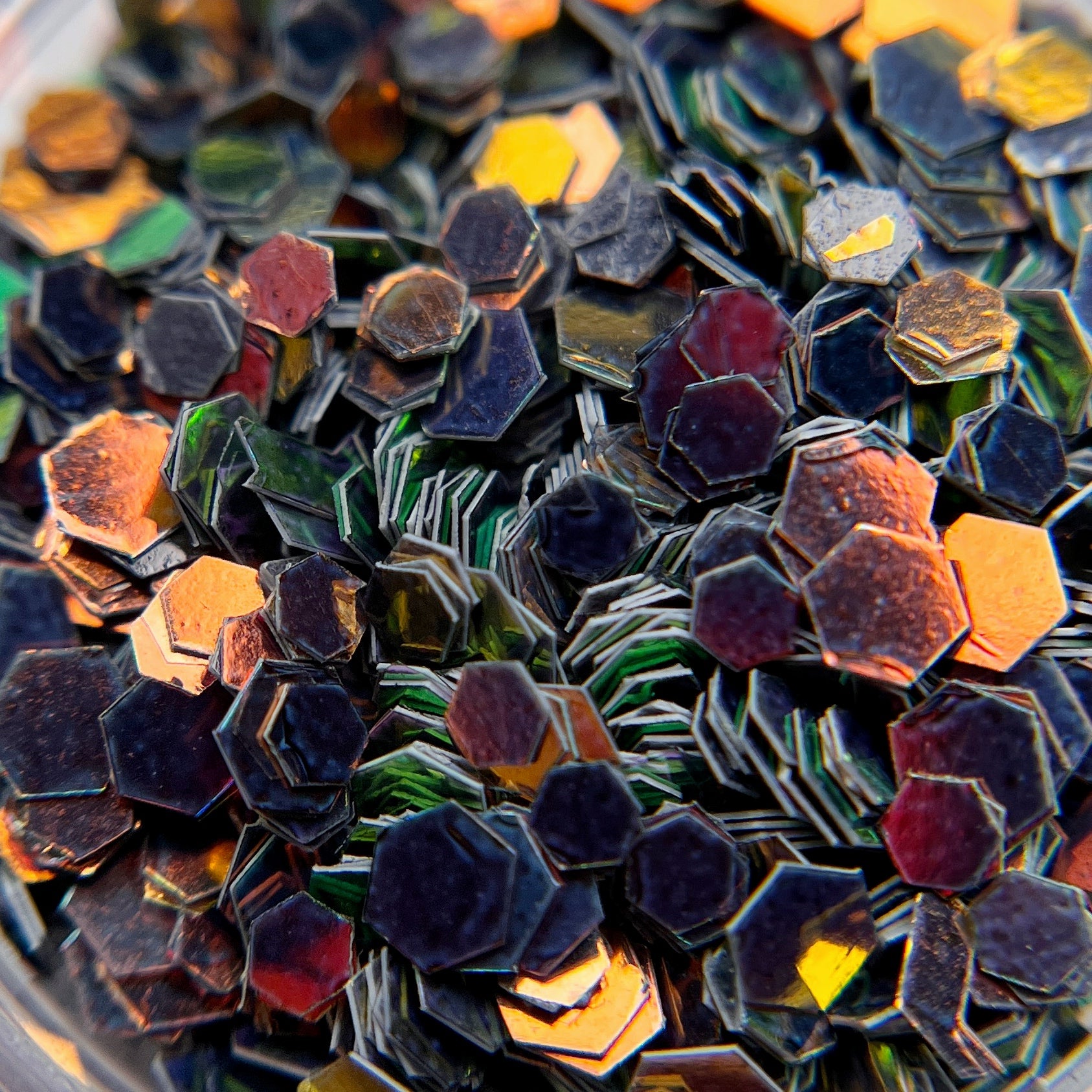 Close up image of iridescent glitter in transparent jar