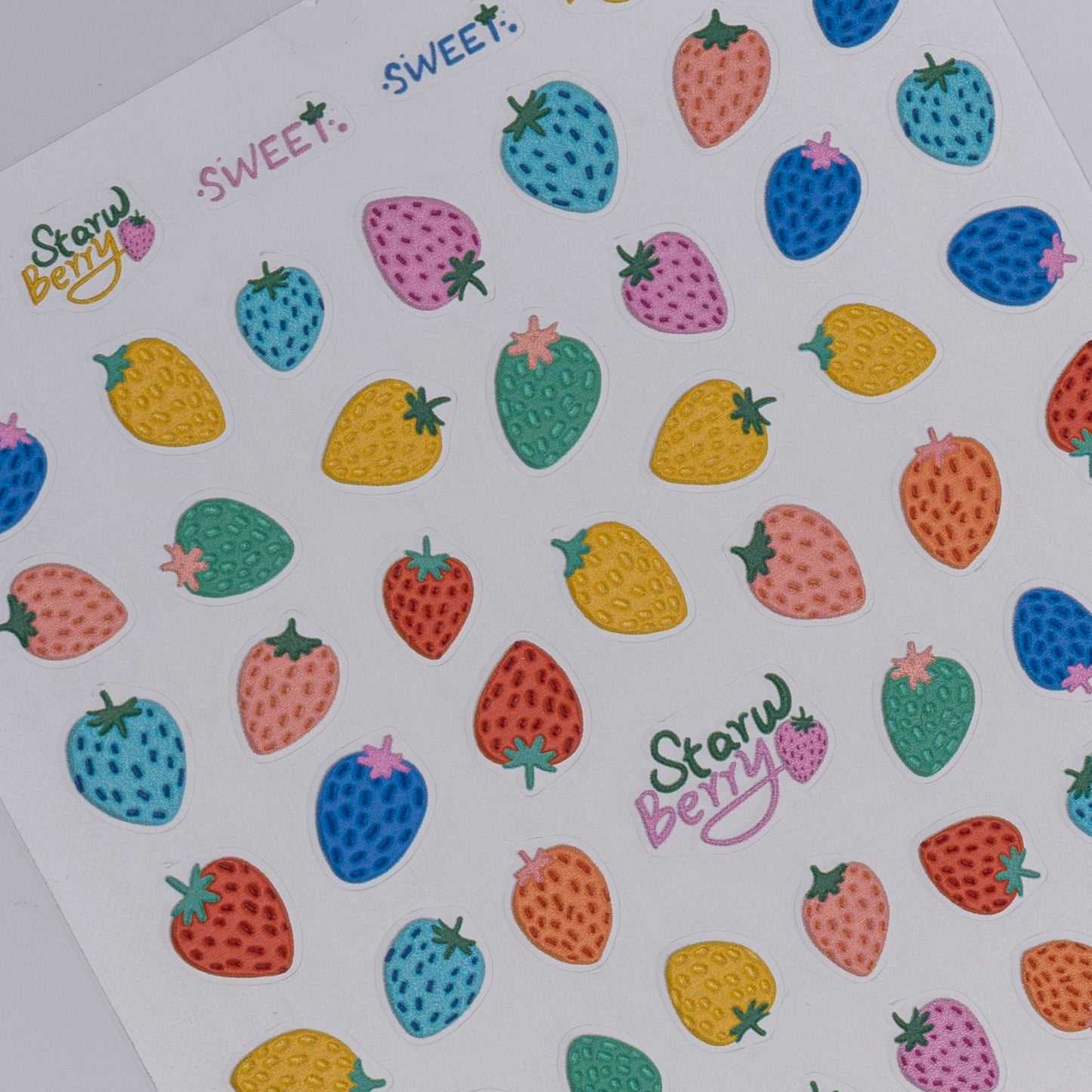 Colorful strawberry stickers with 'Start Berry' branding on a white background
