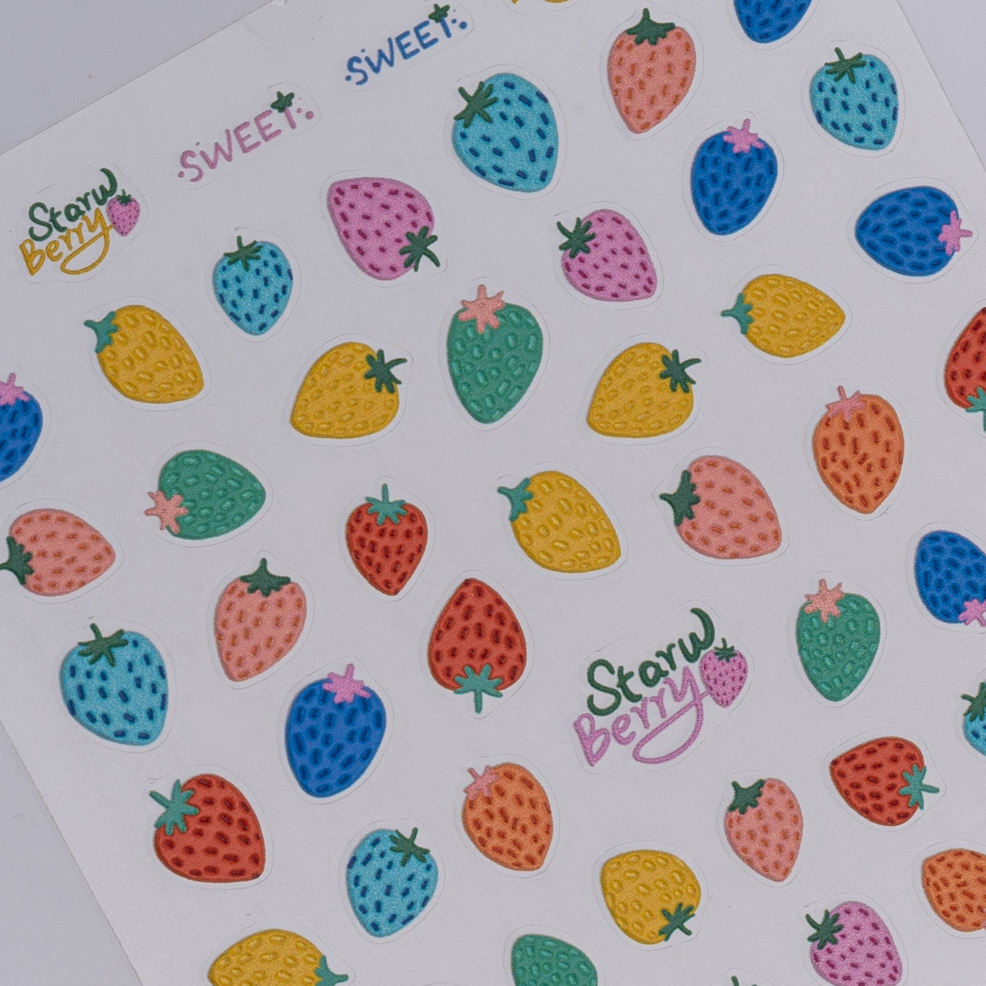 Colorful strawberry stickers with 'Start Berry' branding on a white background