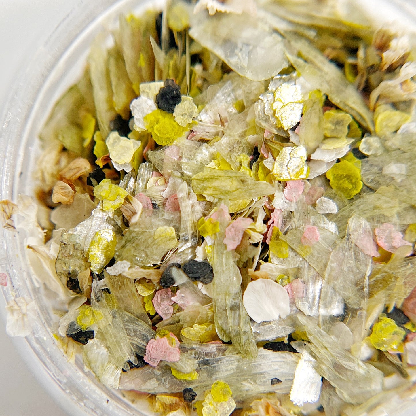 Close up of clear jar with mix of mica flakes