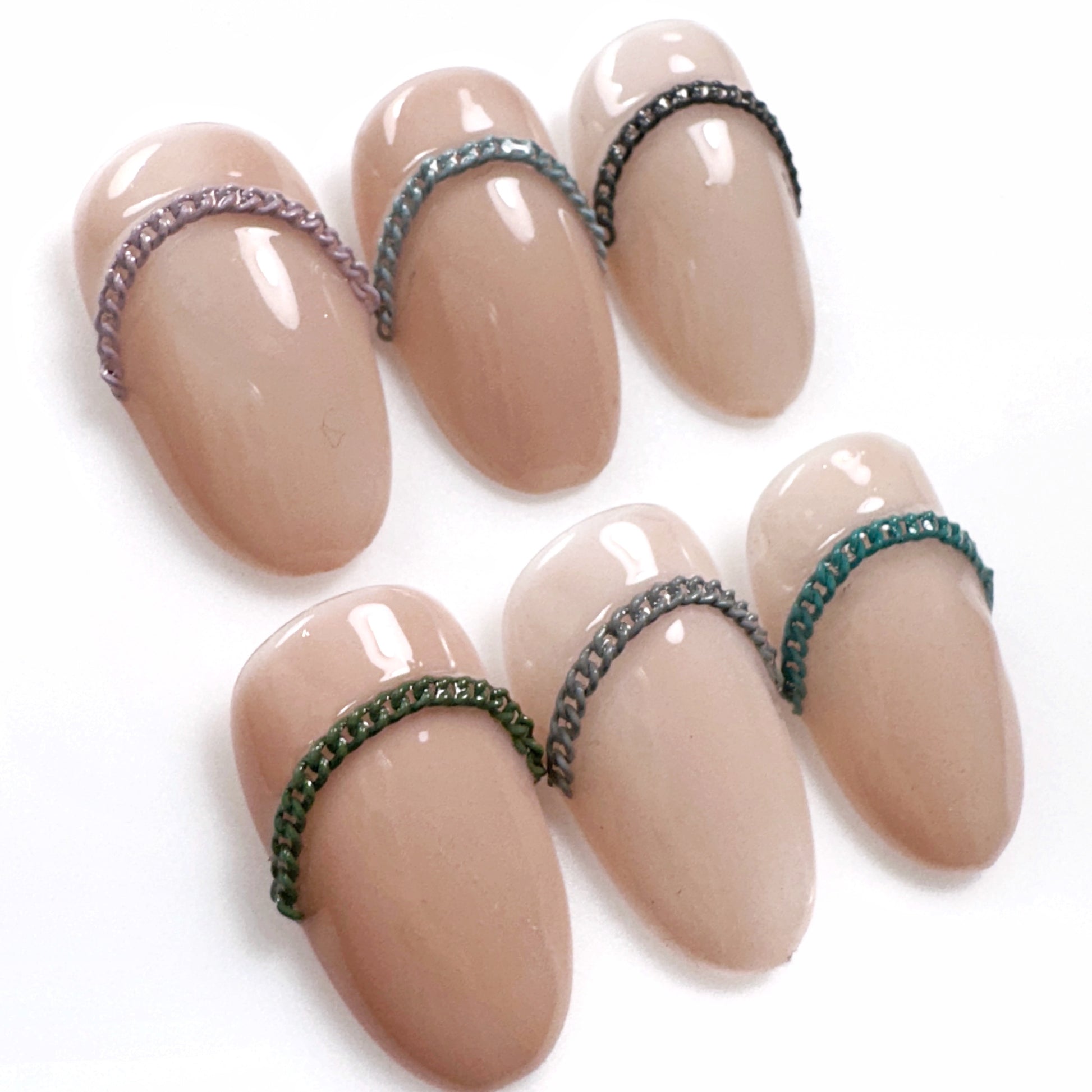 Decorated nail tips on a white surface.