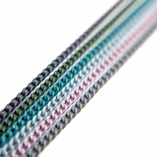 Close-Up of Multi-Color Nail Art Chains in cool blue, green and purple tones on White Background.