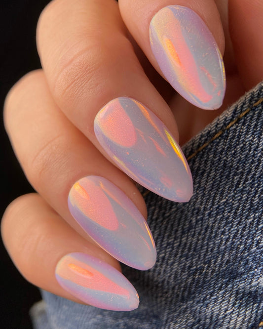Nails with iridescent design on a dark background