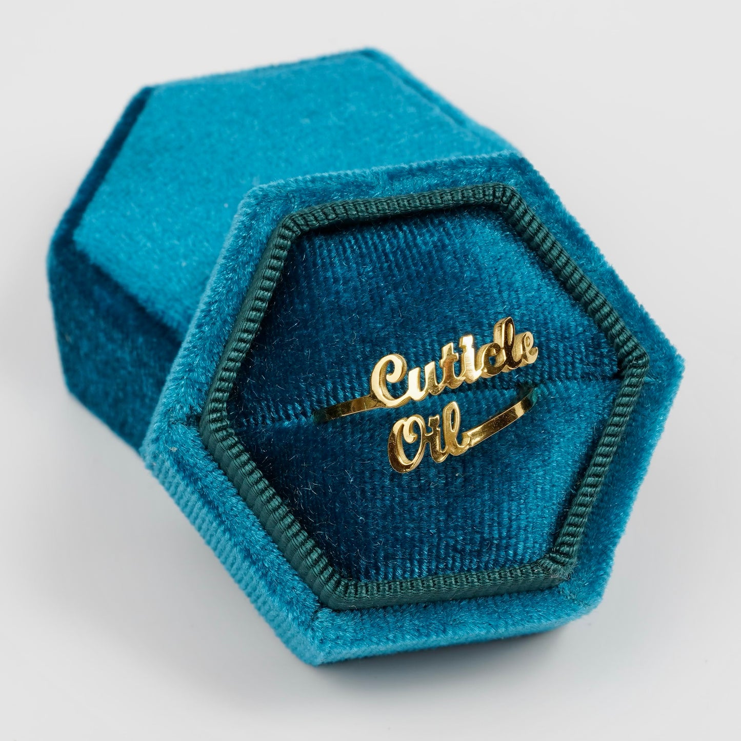 Gold ring in blue ringbox on white background. 