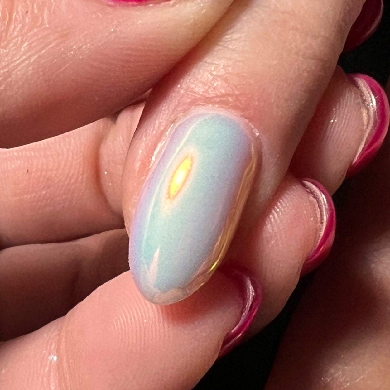 Close up of hand with holding finger on dark background.