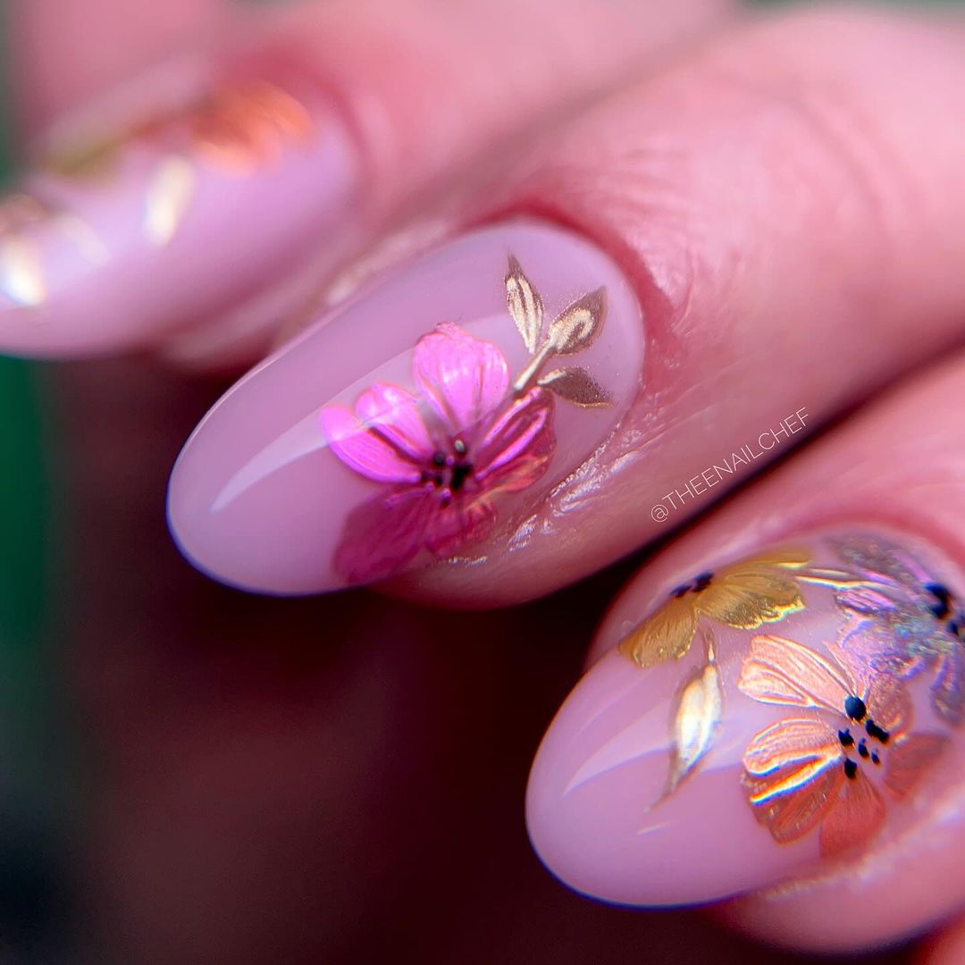 Nails with pink floral and gold leaf designs