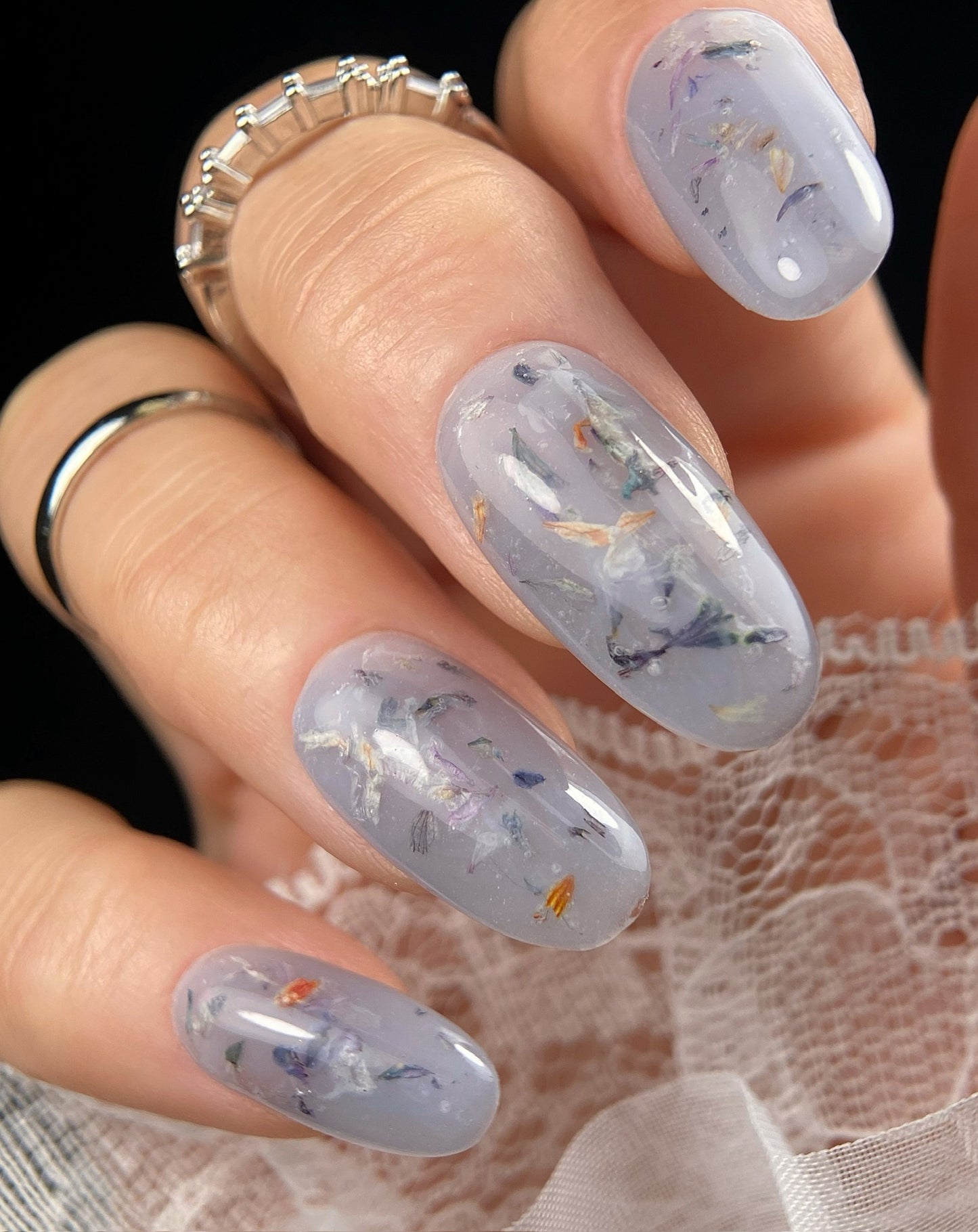 Nails with floral design held by a hand
