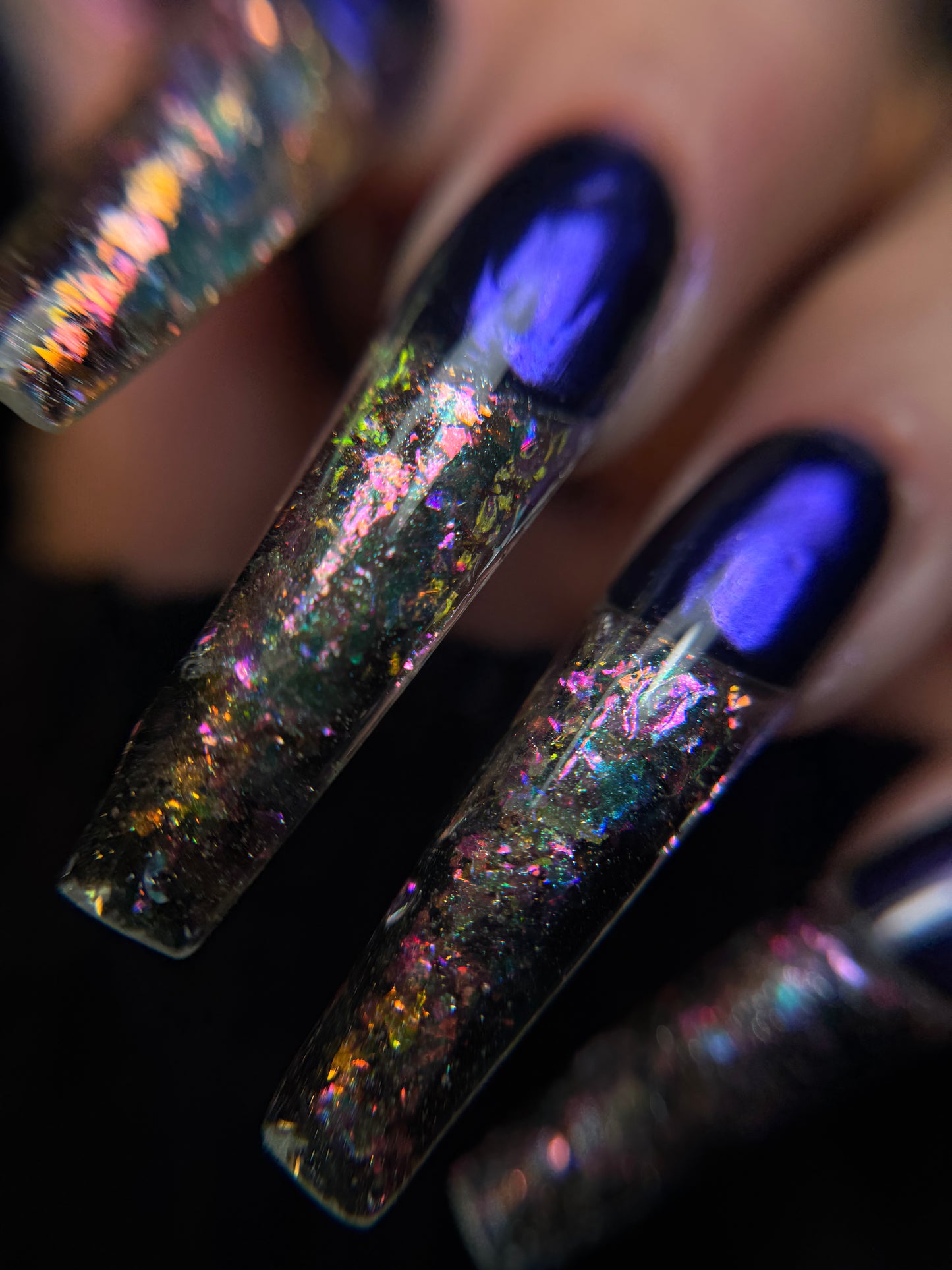 Close-up of glittery nail polishes with a dark background