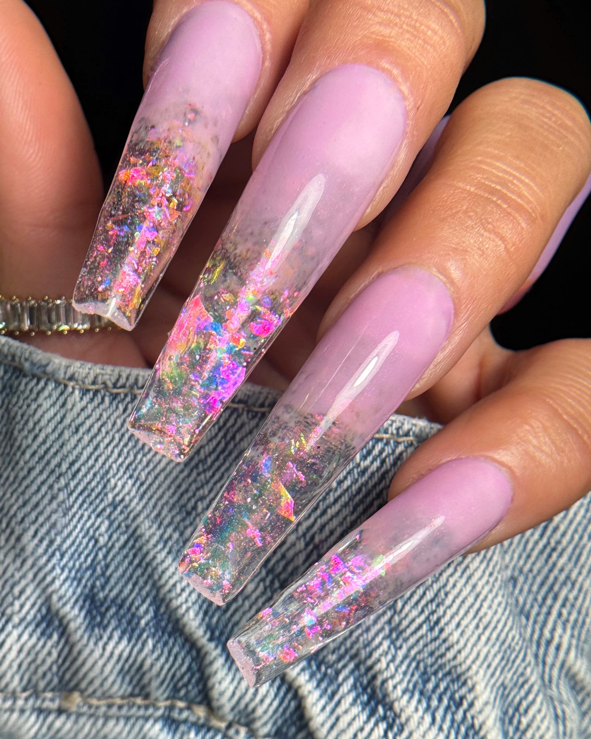 Nails with a glittery design on a denim background