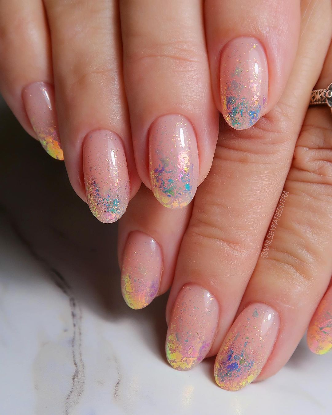 Close up of nails with glittery design on white background 