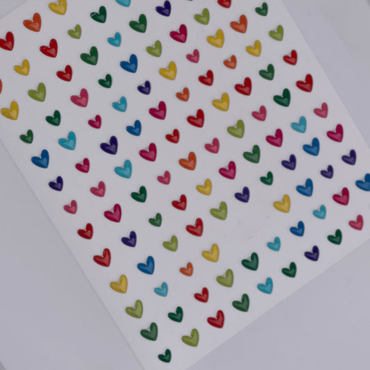 Sheet of colorful heart-shaped stickers on a white background