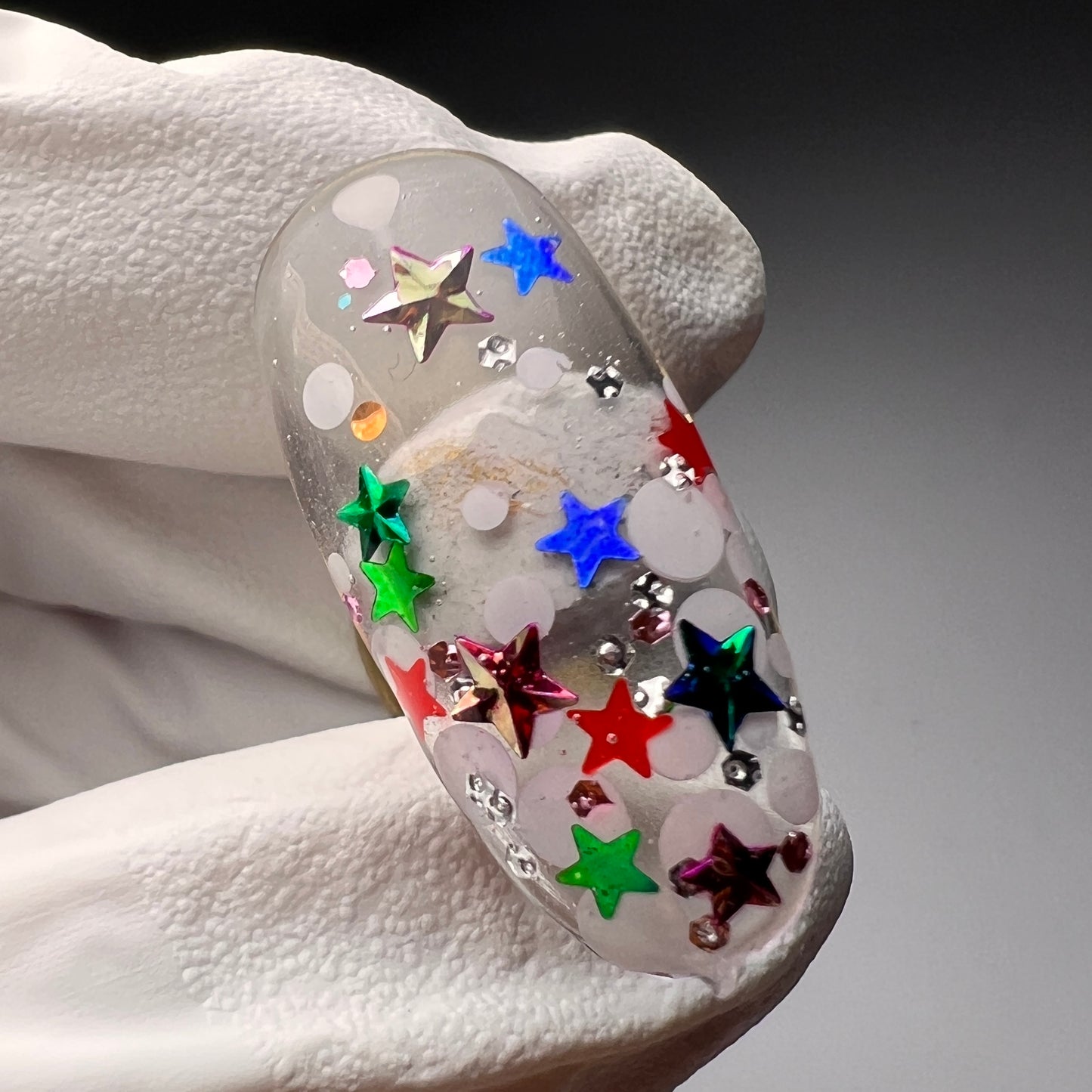 Video of hand holdig decorated nail tips. 