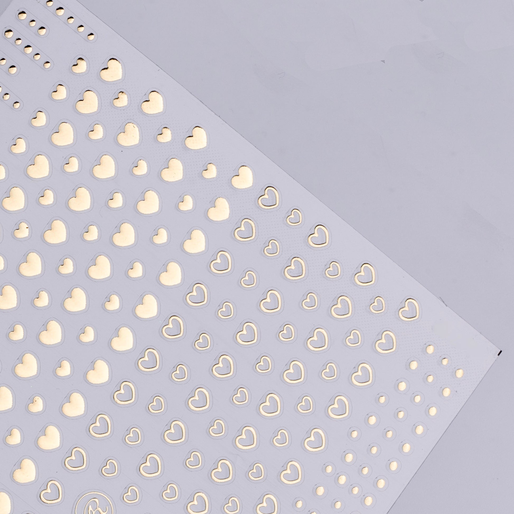 Pattern of gold hearts on a light purple background
