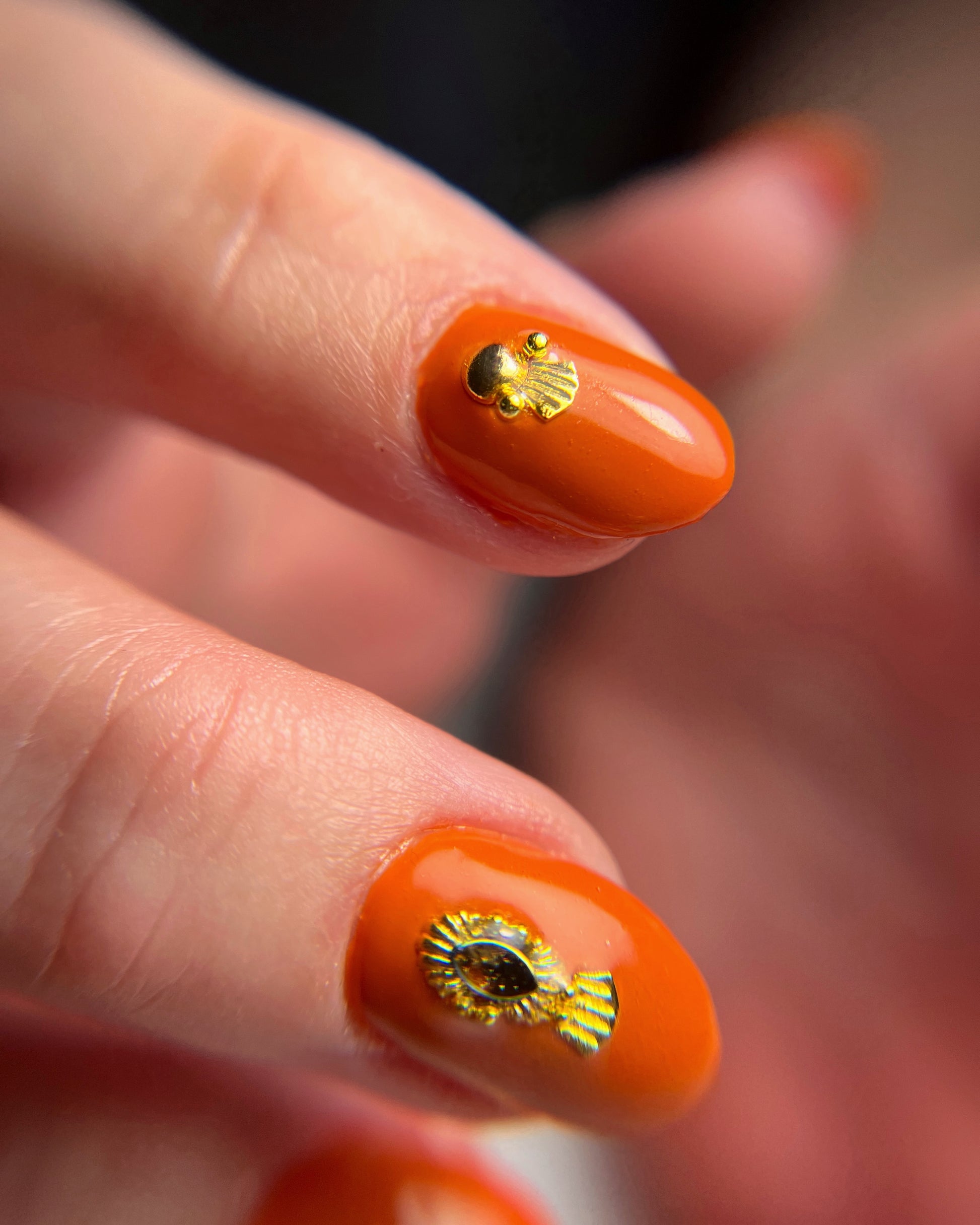 Close up of hand with nail art on dark background
