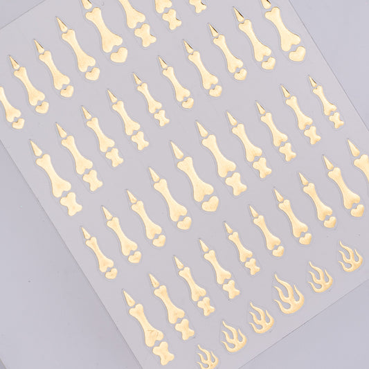 Nail decal sheet featuring gold bones on a gray background