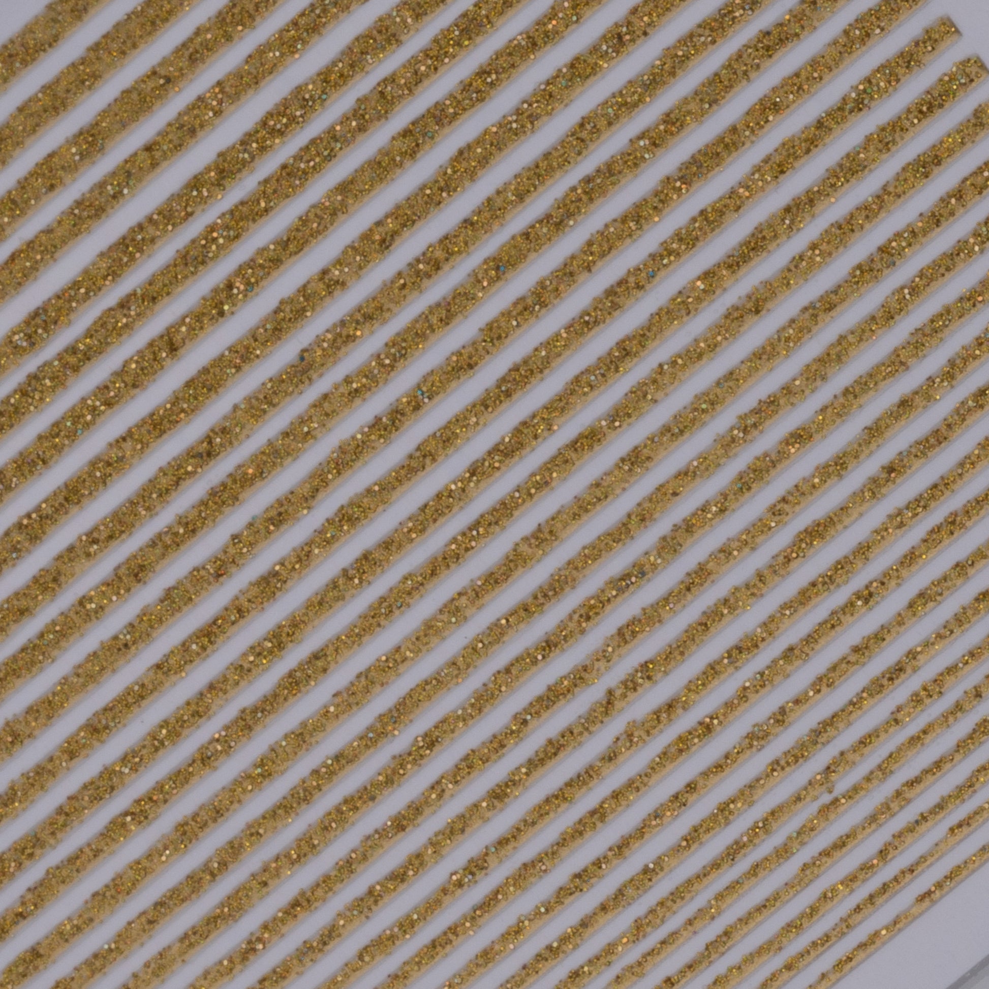 Close-up view of glitter line nail stickers on white background.