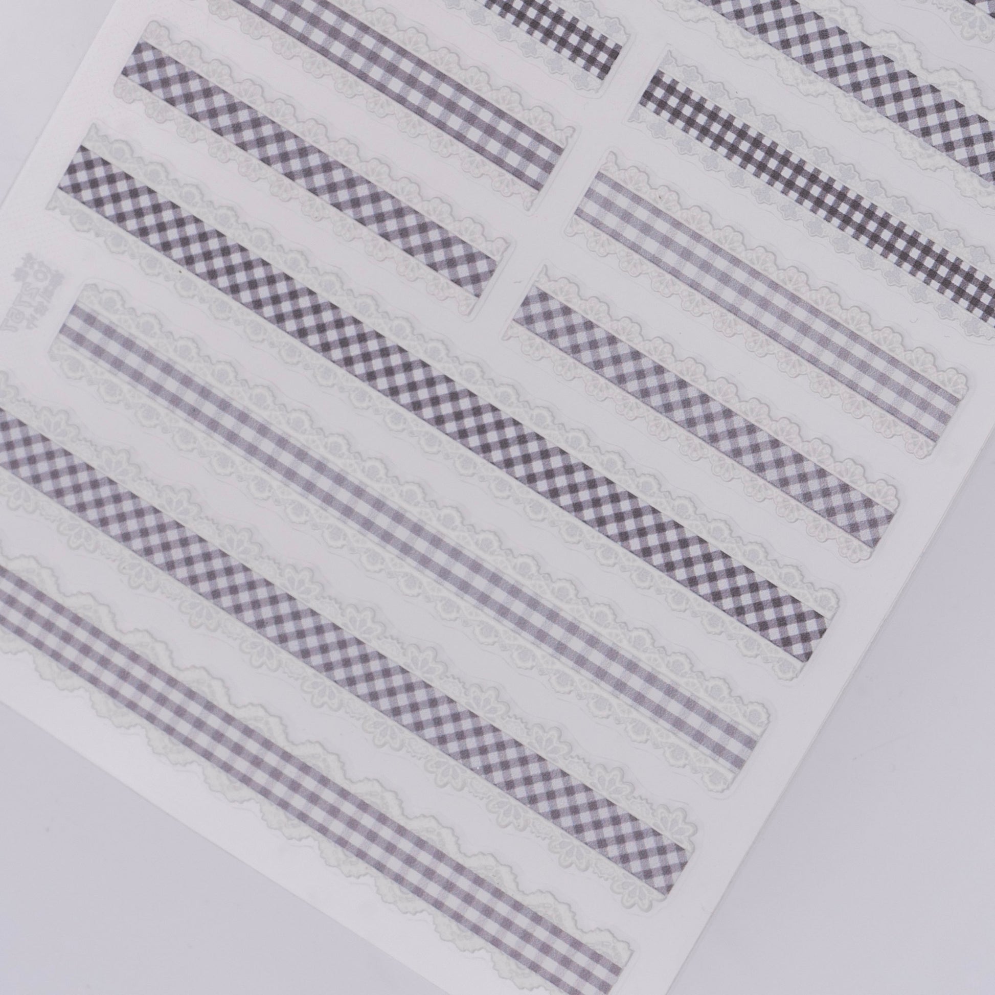 Checker design nail stickers on white background.