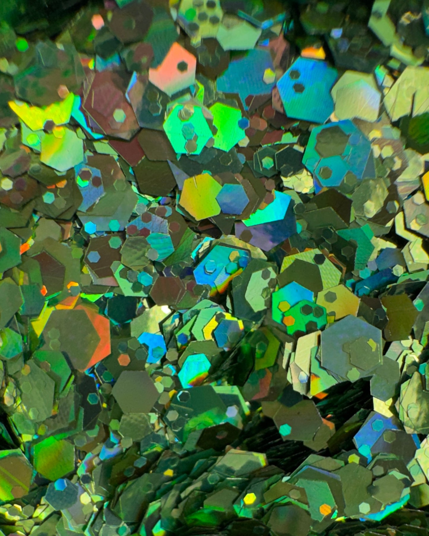 Close-up of metallic hexagonal green glitter mix.