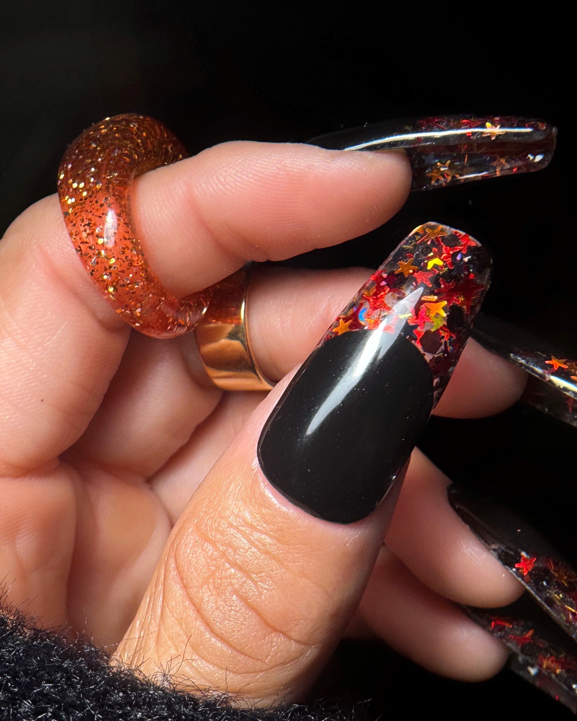 Close-up of a hand with glittery nail design