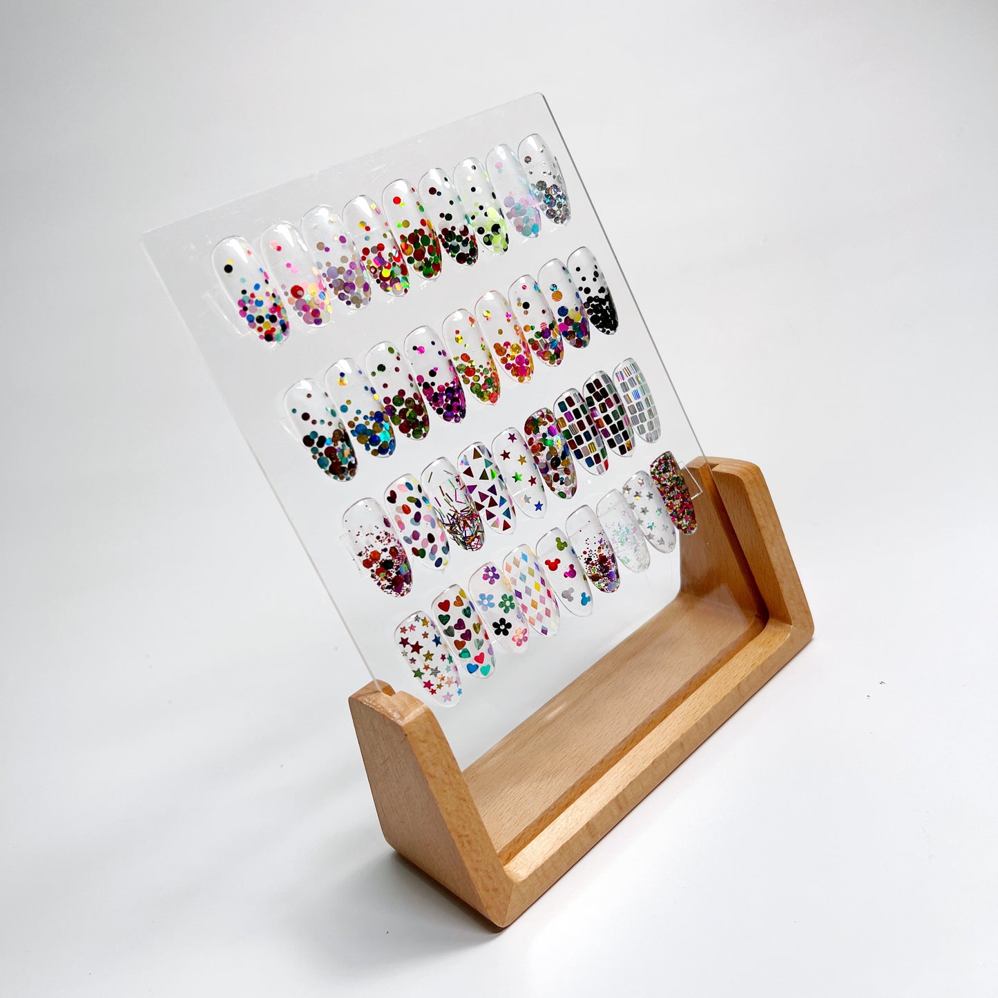Wood Nail Art Display with Sample Nail Art Tips, Presented on White Background.